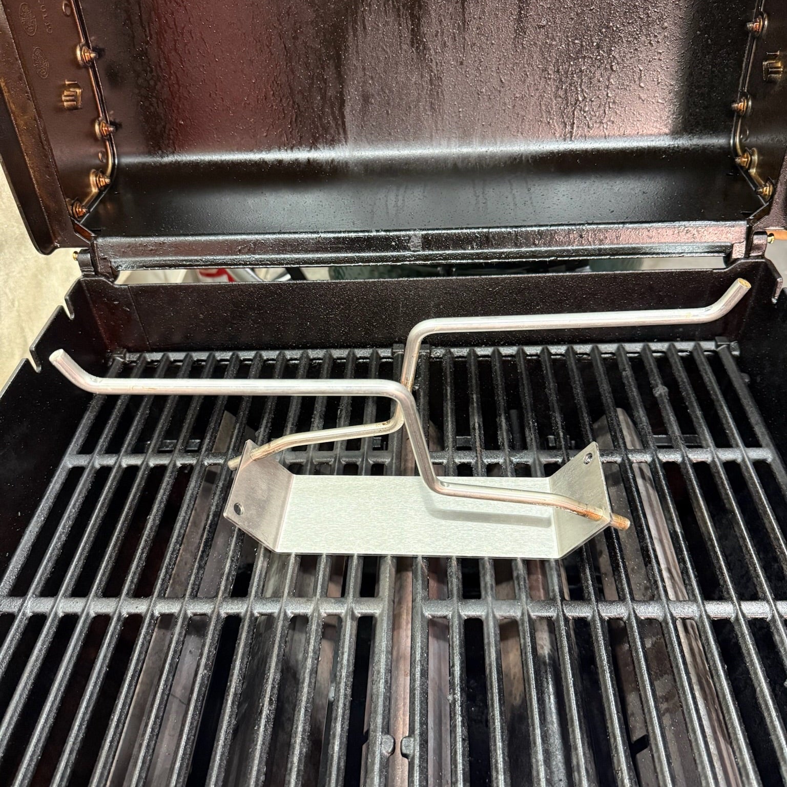 PoulTree Double Coupe with Two Chicken Rods on a grill